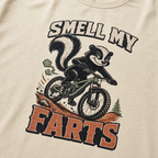 Ivory white t-shirt with a graphic of a badger on a bike and text 'Smell my Farts'.