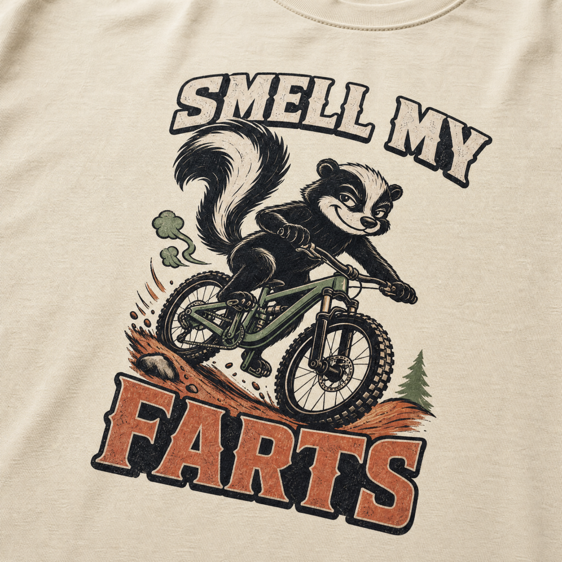 Ivory white t-shirt with a graphic of a badger on a bike and text 'Smell my Farts'.
