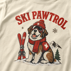 T-shirt with a dog illustration wearing skis and goggles, text 'SKI PAWTROL', on a beige background.