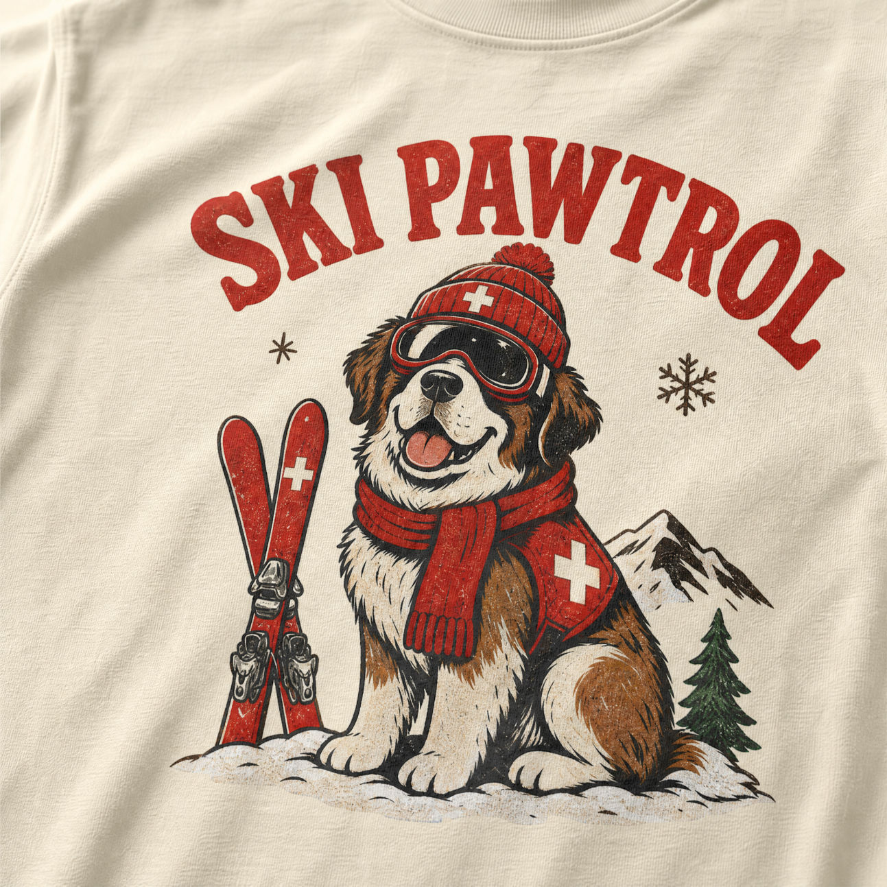 T-shirt with a dog illustration wearing skis and goggles, text 'SKI PAWTROL', on a beige background.