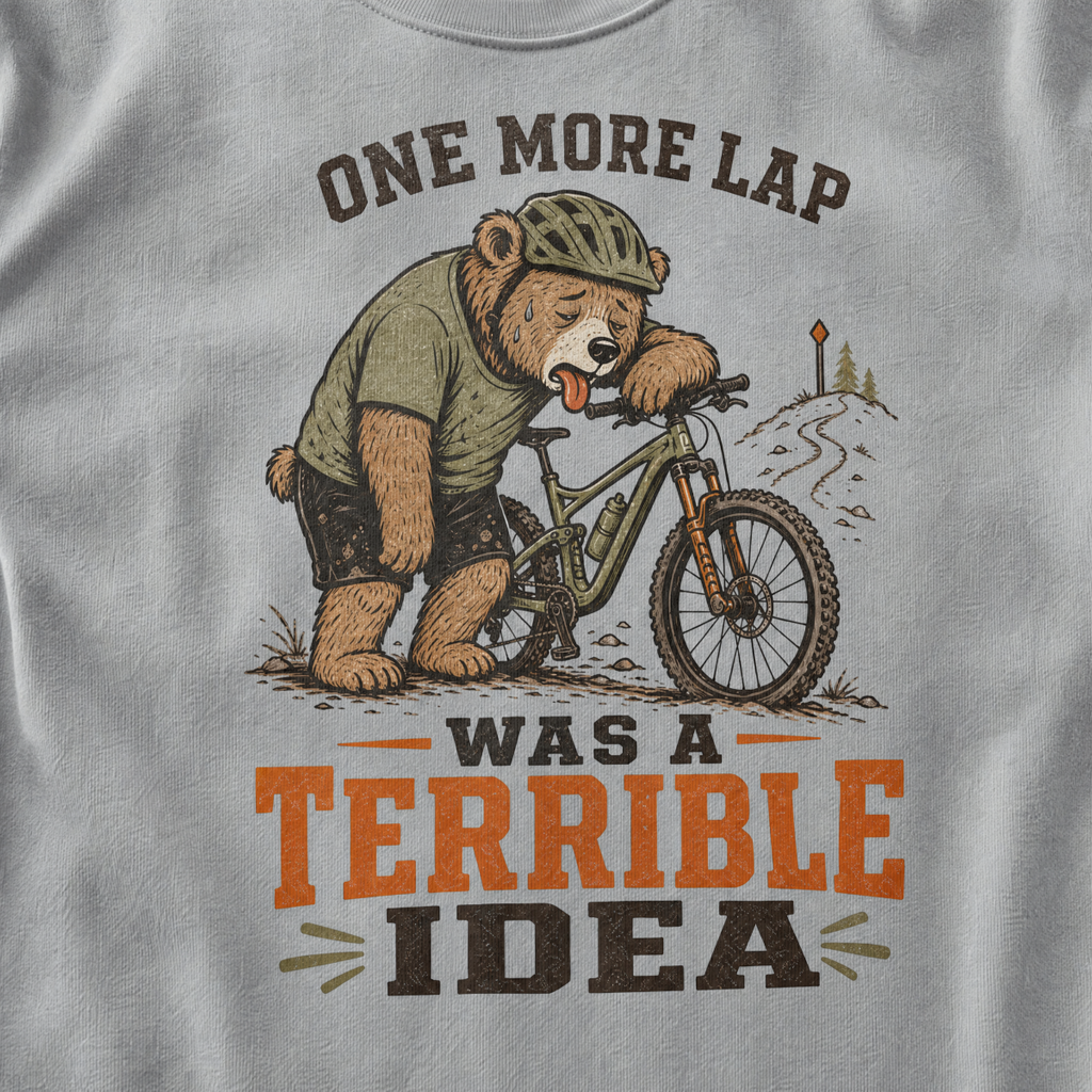 Granite gray t-shirt with a bear graphic and text on a mountain bike
