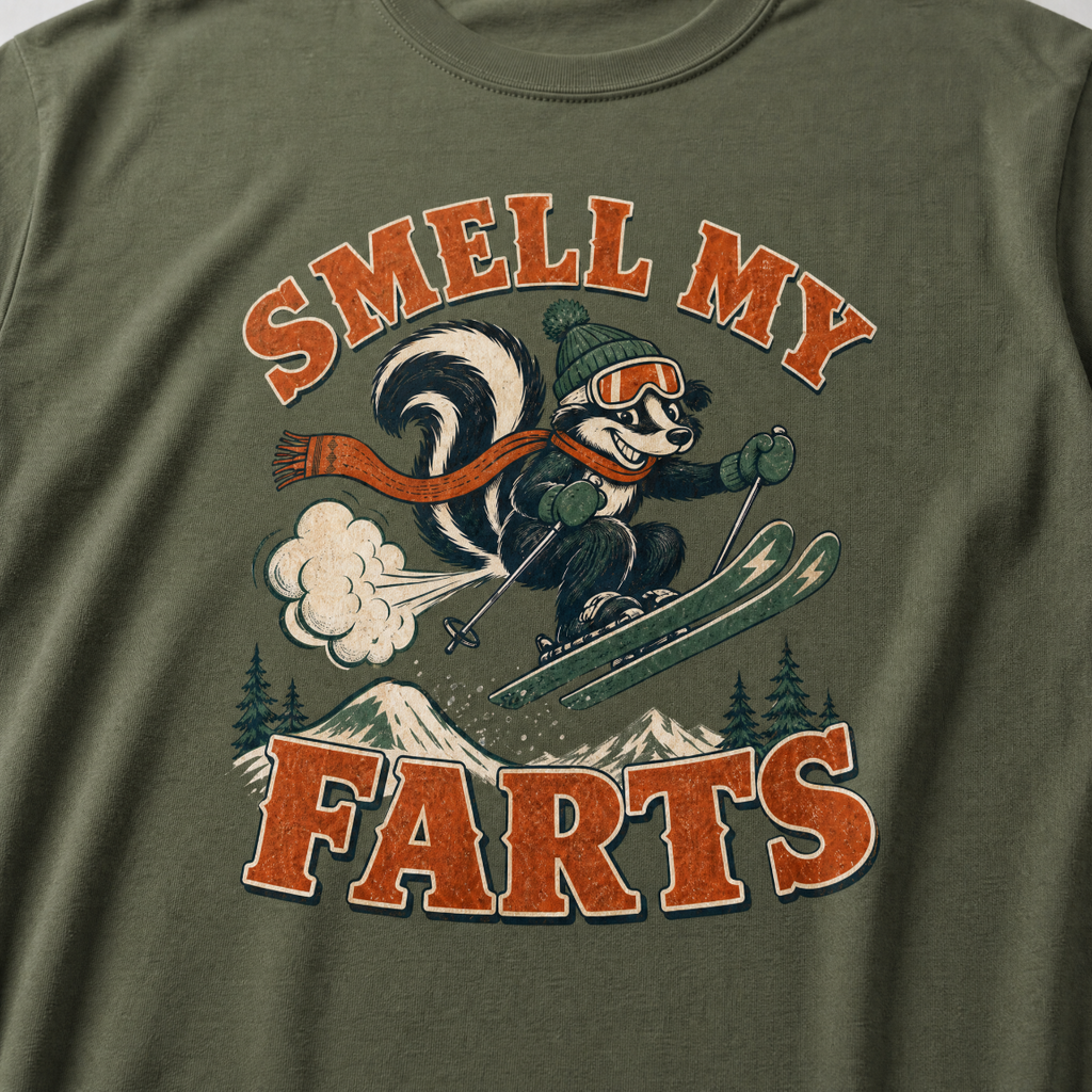 Hemp green t-shirt with a skunk graphic and text 'SMELL MY FARTS' on a mountain background.