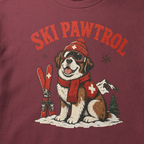 Brick red t-shirt with a dog graphic and 'Ski Pawtrol' text on a snowy background.