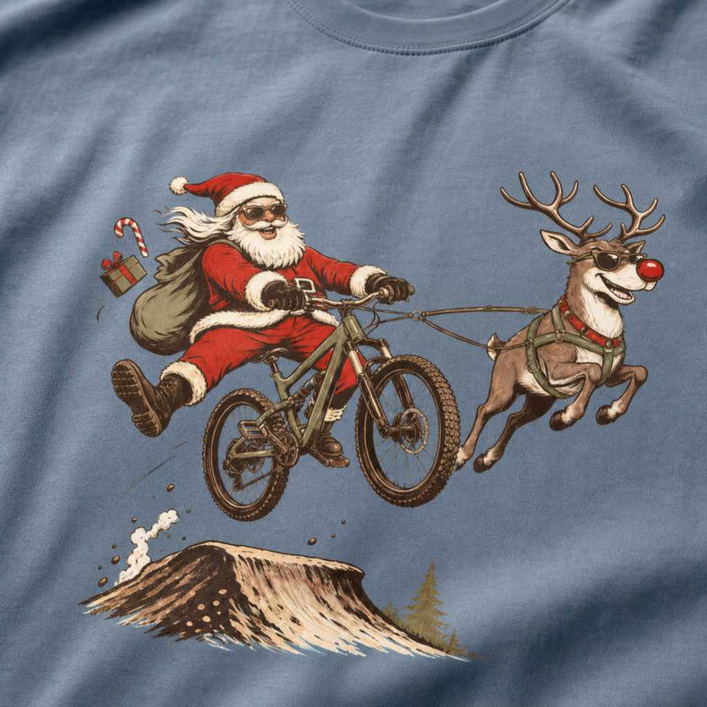 T-shirt with a graphic of Santa Claus riding a bike with a reindeer, on a blue background.