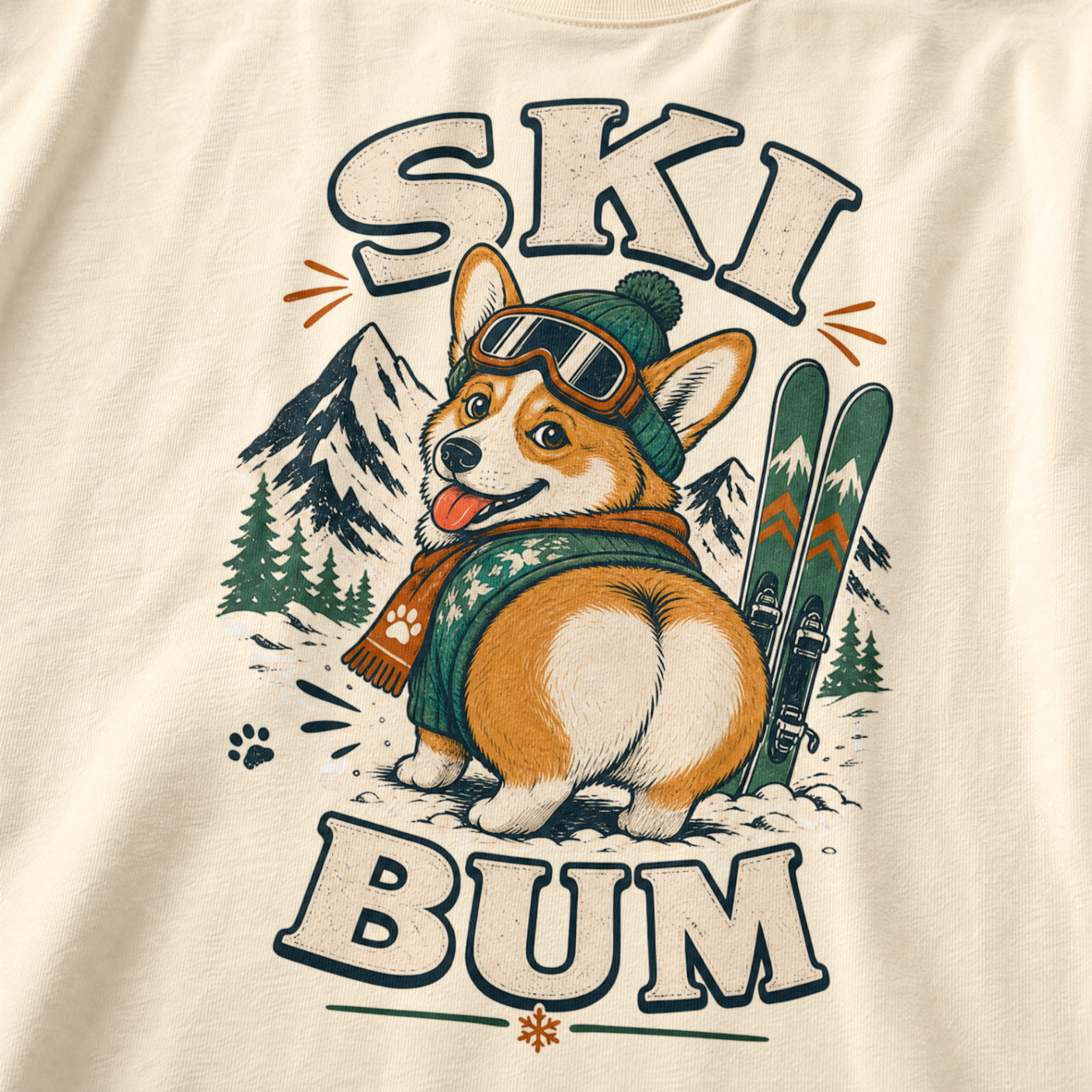 T-shirt with a corgi wearing skis and goggles, surrounded by mountains and trees, with 'Ski Bum' text.