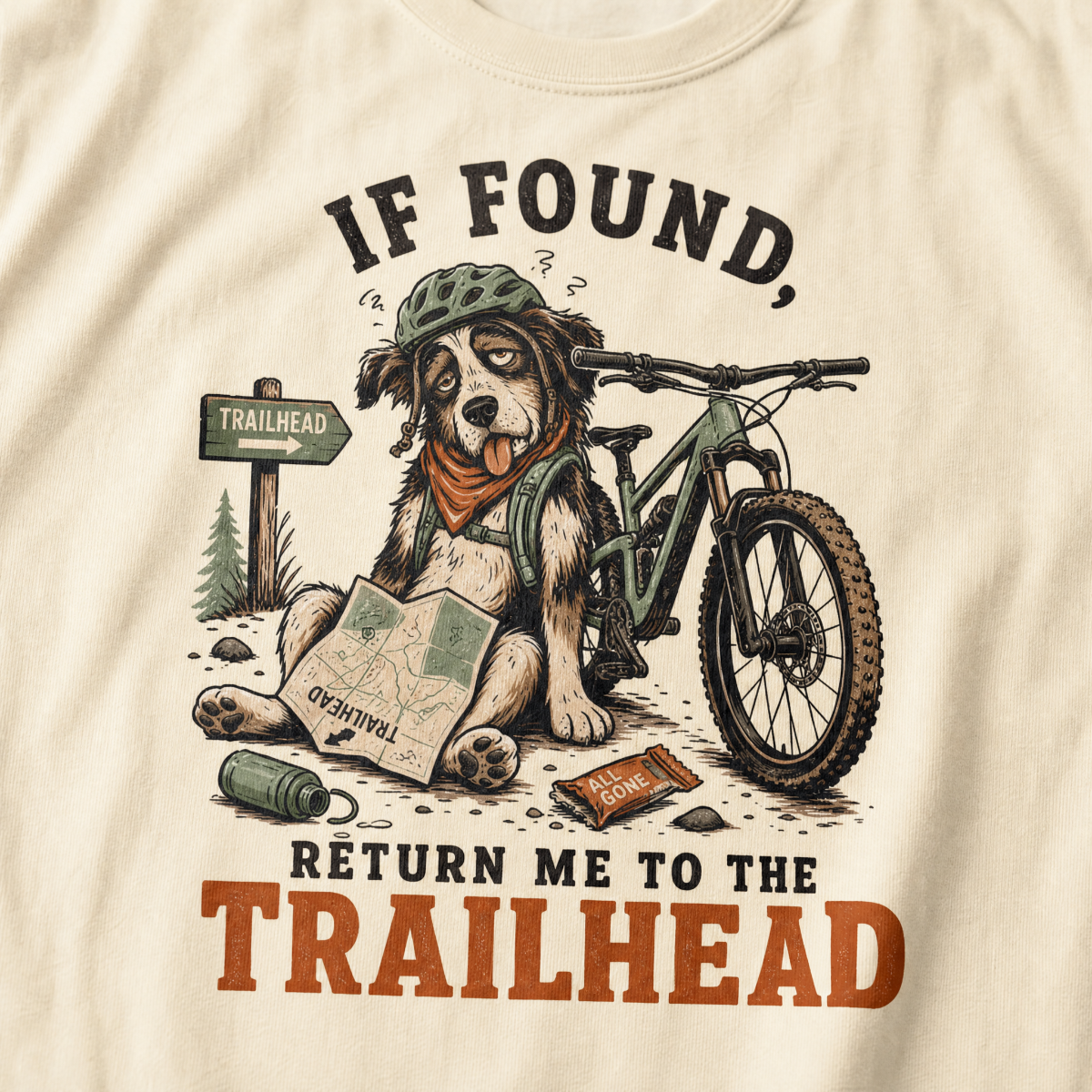 T-shirt with a dog illustration and 'If found, return me to the trailhead' text on an ivory white background.