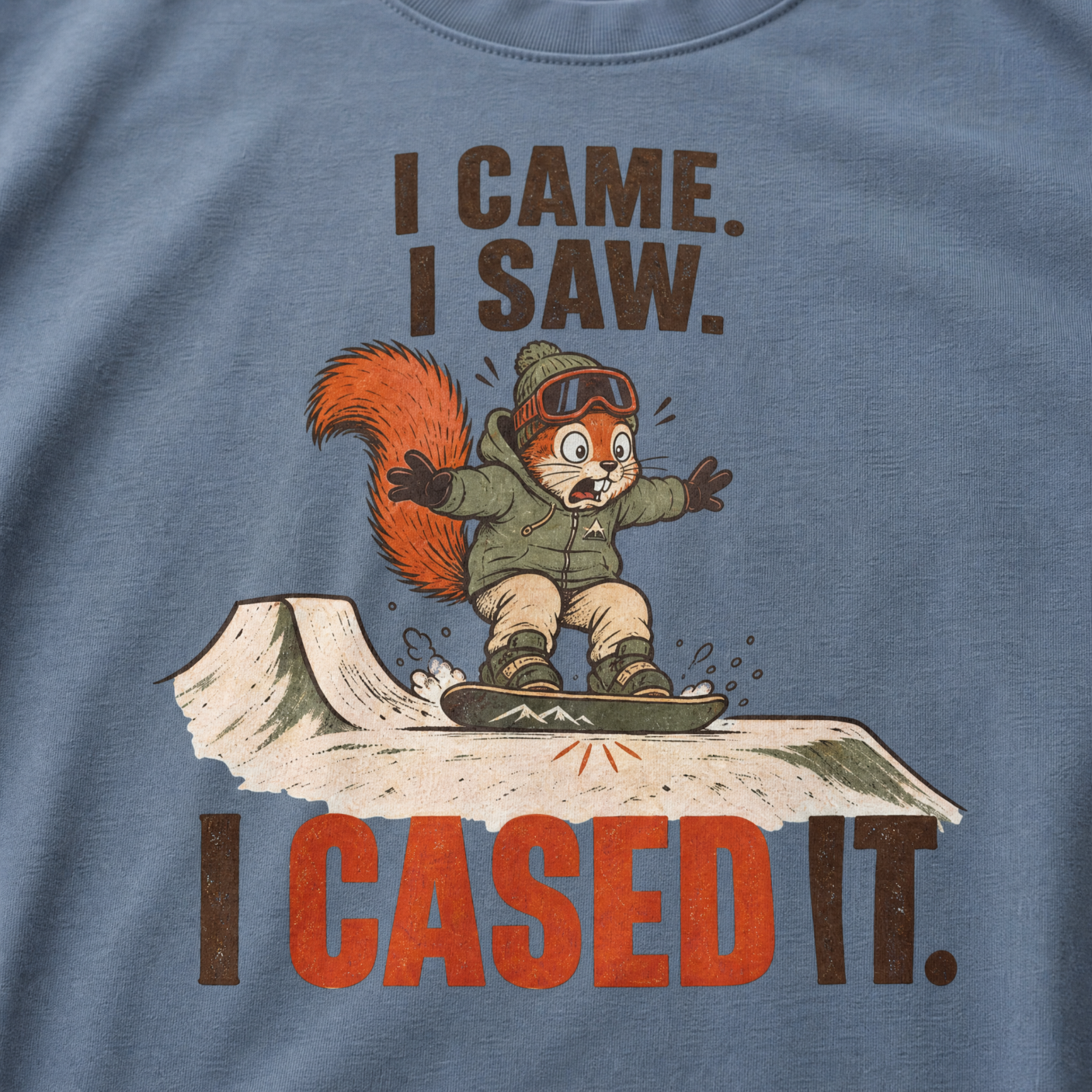 Blue jean colored t-shirt of a squirrel snowboarding with text, "I CAME. I SAW. I CASED IT"