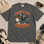 Pepper gray t-shirt with a graphic design and text, surrounded by winter accessories on a beige background