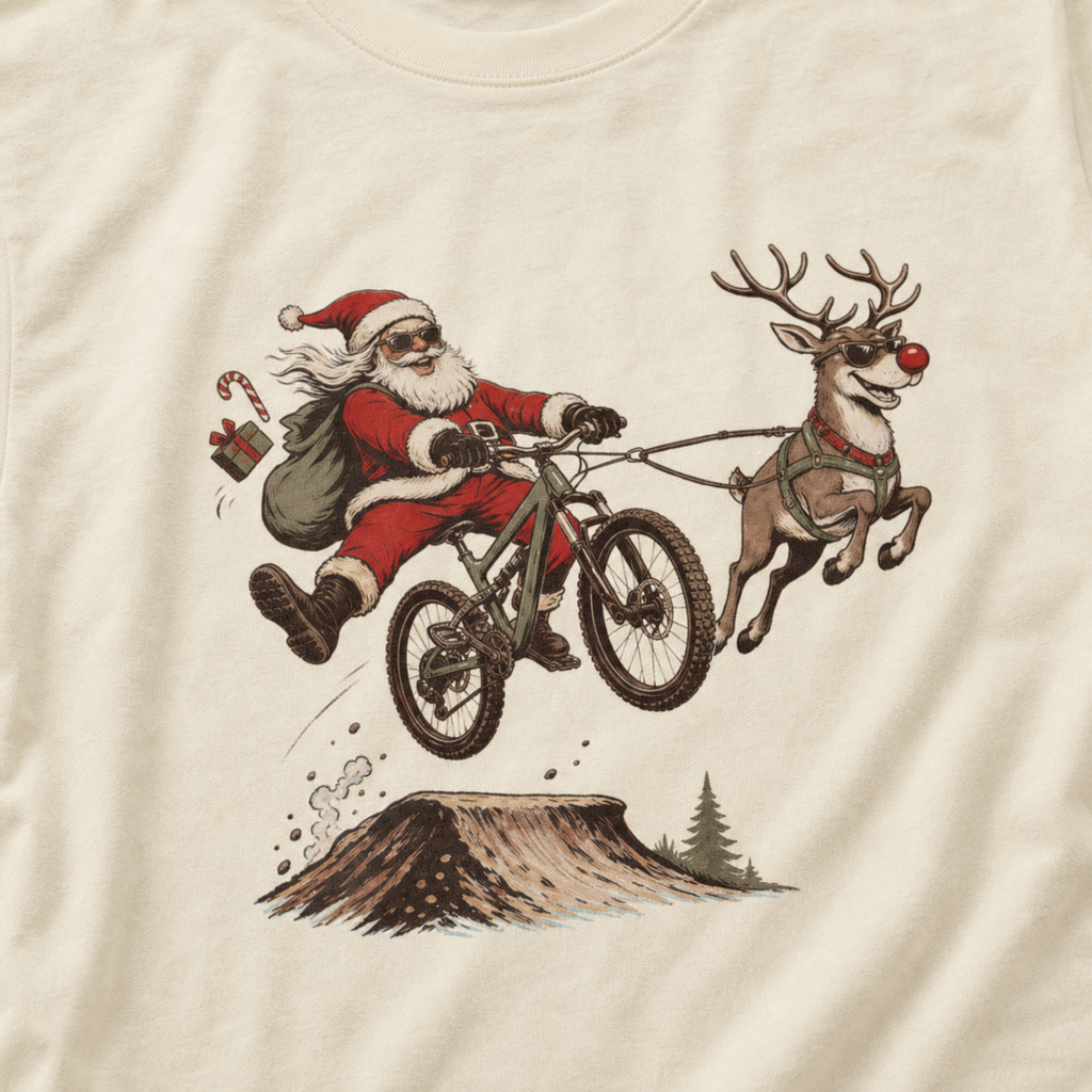 T-shirt with a graphic of Santa Claus riding a bike with a reindeer.