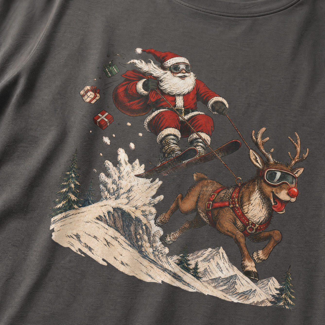 T-shirt with a graphic of Santa Claus snowboarding with a reindeer on a mountain.
