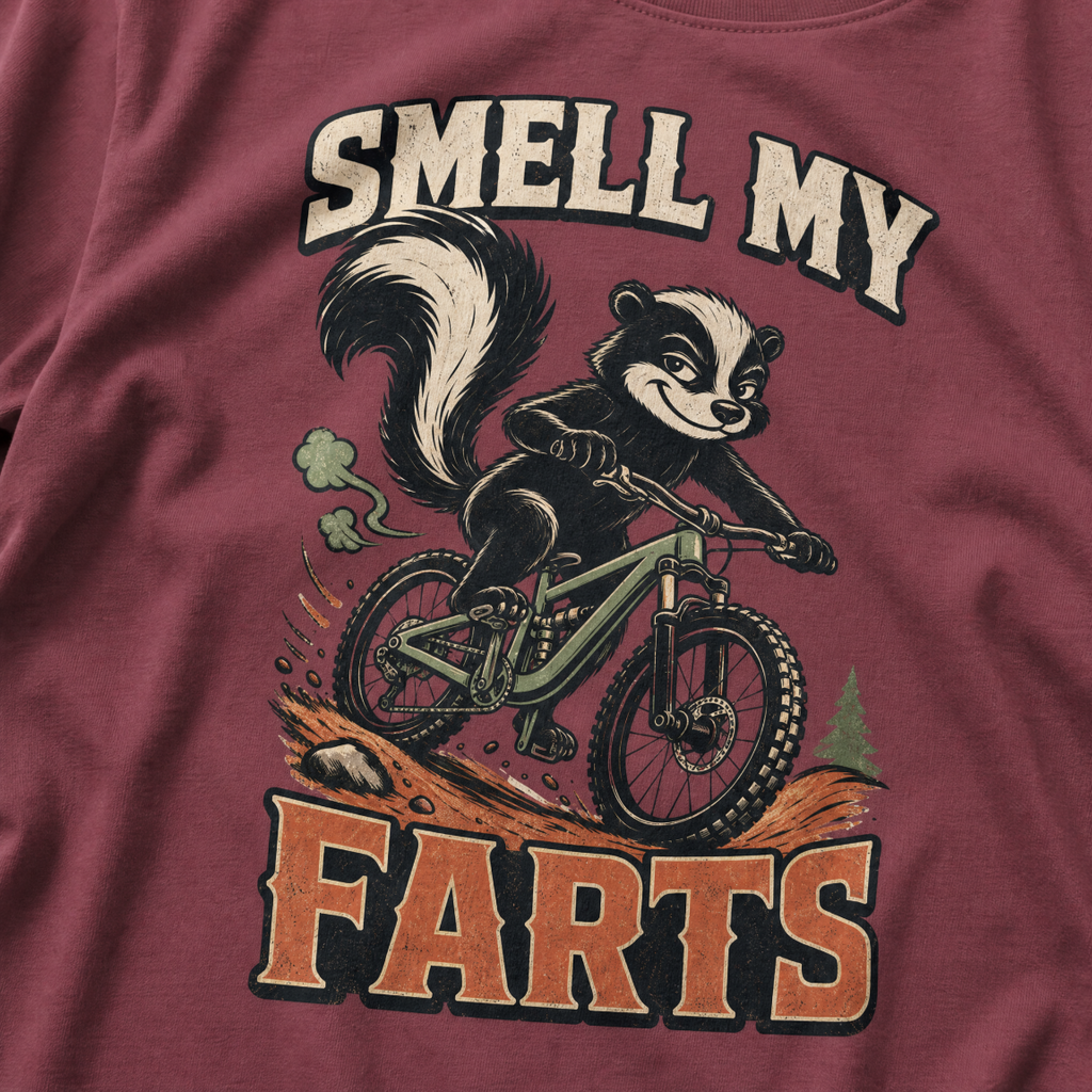 Brick red t-shirt with a graphic of a badger on a bike and text 'SMELL MY FARTS'.