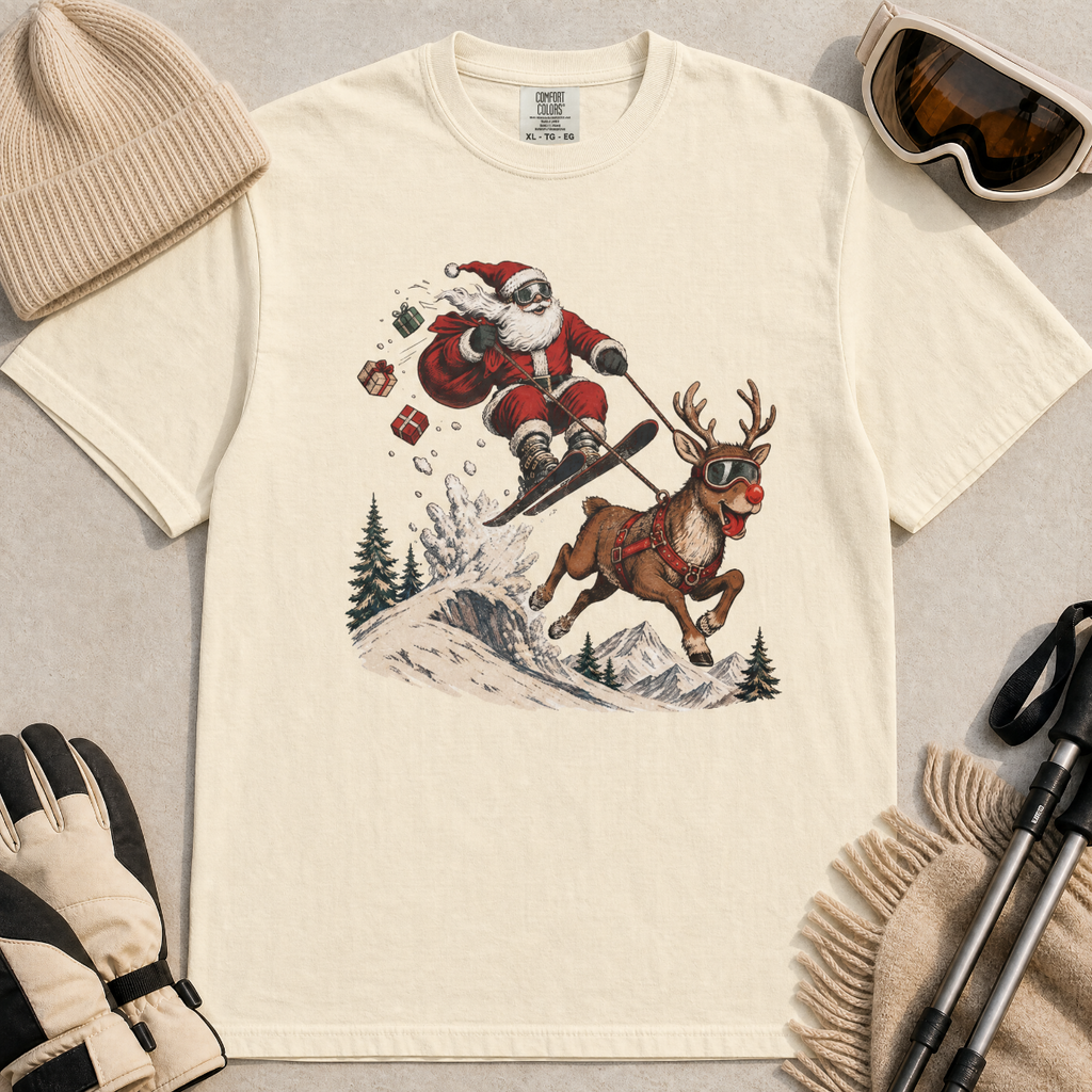 Ivory white t-shirt with Santa Claus and reindeer graphic, surrounded by winter accessories on a beige background