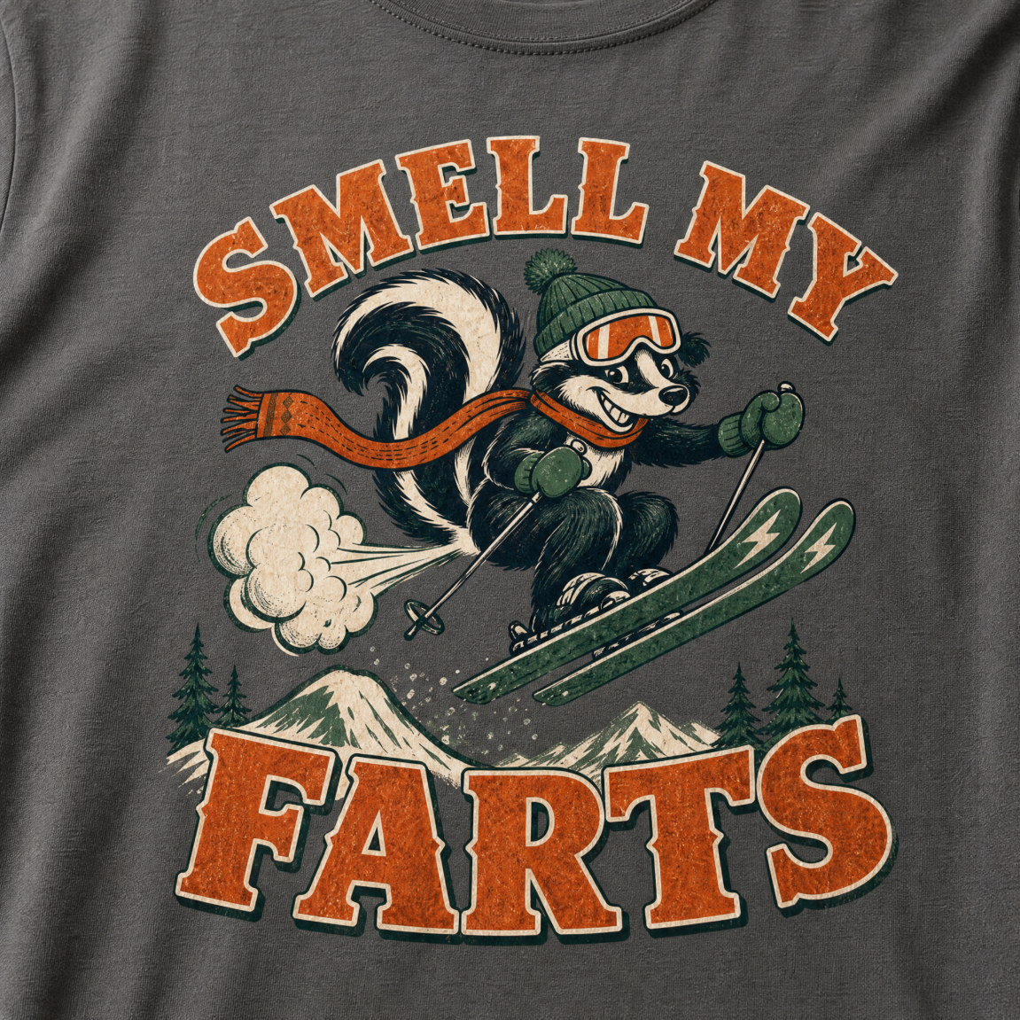 T-shirt with a skunk character skiing and text 'Smell my farts' on a dark gray background