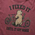 T-shirt with a beaver and bicycle graphic and text on a brick red background