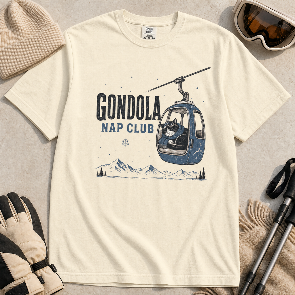 Ivory white t-shirt featuring a cat napping in a ski gondola with text, "Gondola Nap Club".