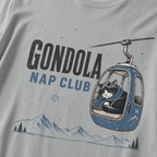 Granite gray t-shirt featuring a cat napping in a ski gondola with text, "Gondola Nap Club".