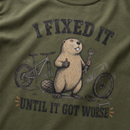 Hemp green t-shirt with a beaver holding a wrench and a bicycle, text 'I FIXED IT UNTIL IT GOT WORSE' on a green background.