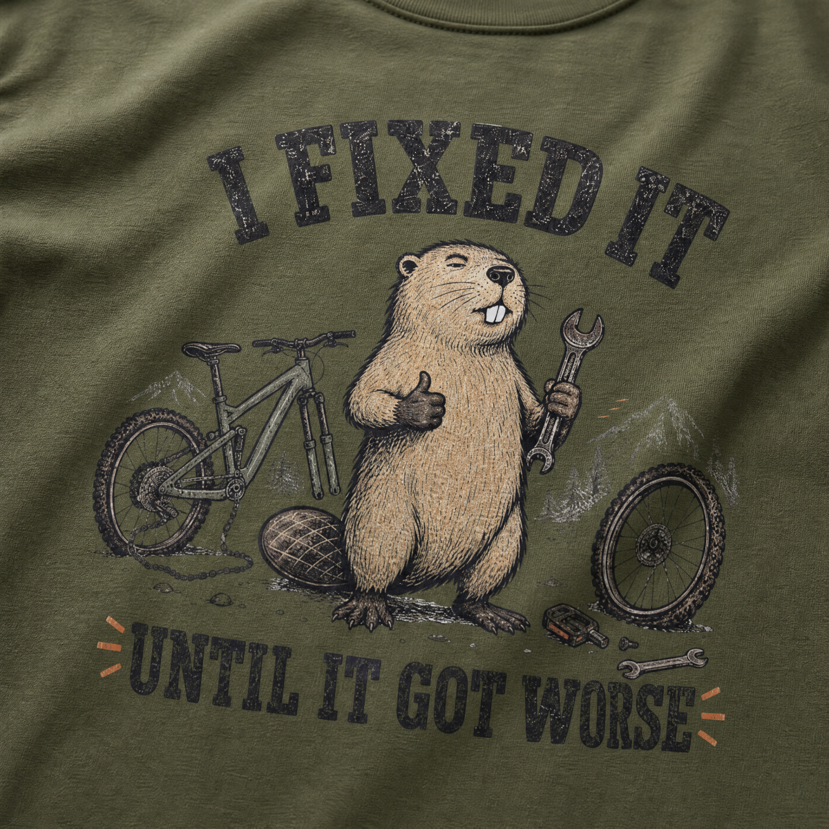 Hemp green t-shirt with a beaver holding a wrench and a bicycle, text 'I FIXED IT UNTIL IT GOT WORSE' on a green background.