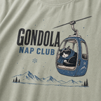 Bay green t-shirt featuring a cat napping in a ski gondola with text, "Gondola Nap Club".
