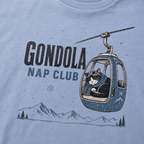 Washed denim blue t-shirt featuring a cat napping in a ski gondola with text, "Gondola Nap Club".