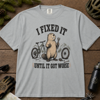 Graphite gray t-shirt with beaver graphic and text on a wooden surface with bike-related items.