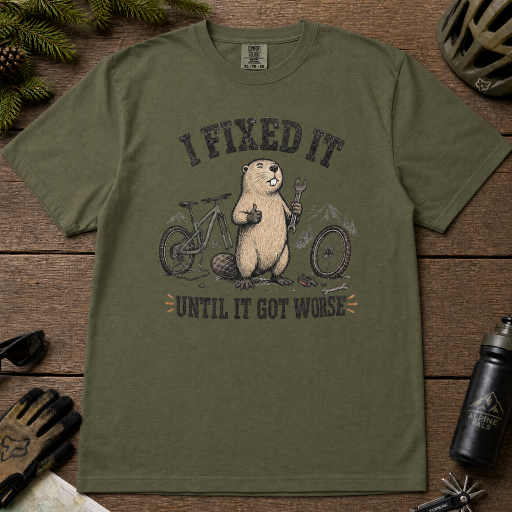 Hemp green t-shirt with graphic design of a beaver and text on a wooden surface with accessories.