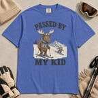Flat lay of a mystic blue t-shirt featuring a funny “Passed By My Kid” ski design with a humbled moose watching a small rabbit snowboarder pass by.