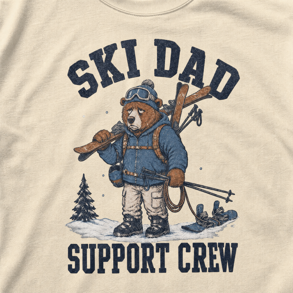 Close-up of an ivory white t-shirt with a vintage ski dad design showing an exhausted bear loaded with skis, poles, and snow gear.