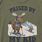 Close-up of a moss green t-shirt with a vintage “Passed By My Kid” design showing an embarrassed moose skier being passed by a tiny rabbit snowboarder.