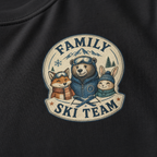 Close-up of a black t-shirt with a retro badge design showing a bear, fox, and rabbit as a “Family Ski Team.”