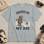 Flat lay of a granite gray t-shirt featuring a funny “Passed By My Kid” ski design with a humbled moose watching a small rabbit snowboarder pass by.