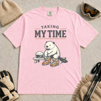 Blossom tee featuring a relaxed beaver sitting on a bench in ski boots beside a helmet and goggles, with the phrase “Taking My Time.”