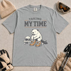 Granite tee featuring a relaxed beaver sitting on a bench in ski boots beside a helmet and goggles, with the phrase “Taking My Time.”