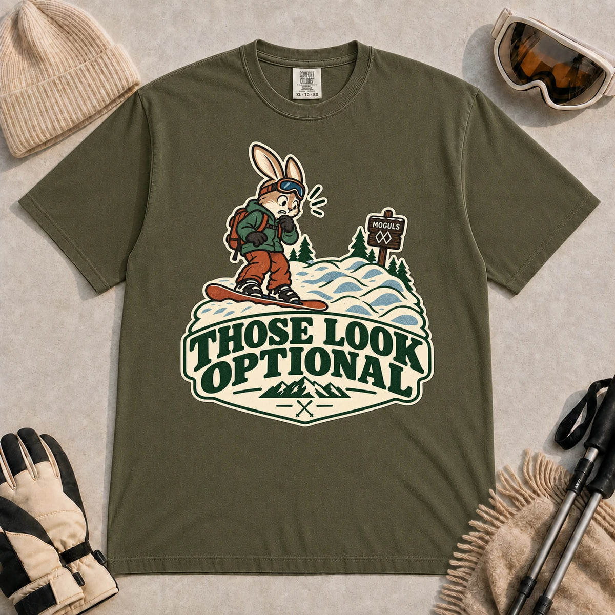 Hemp tee featuring a cautious bunny snowboarder facing a mogul run beside a “Moguls” sign above the phrase “Those Look Optional.”