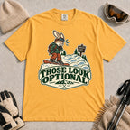Mustard tee featuring a cautious bunny snowboarder facing a mogul run beside a “Moguls” sign above the phrase “Those Look Optional.”