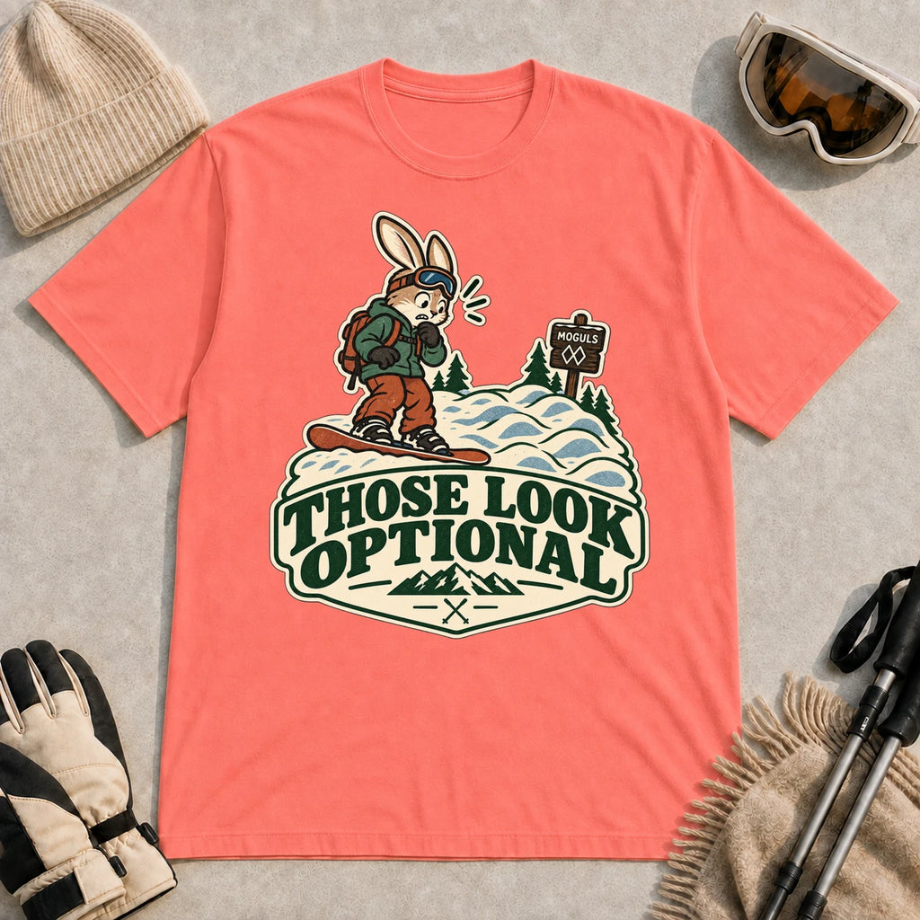 Coral Silk tee featuring a cautious bunny snowboarder facing a mogul run beside a “Moguls” sign above the phrase “Those Look Optional.”