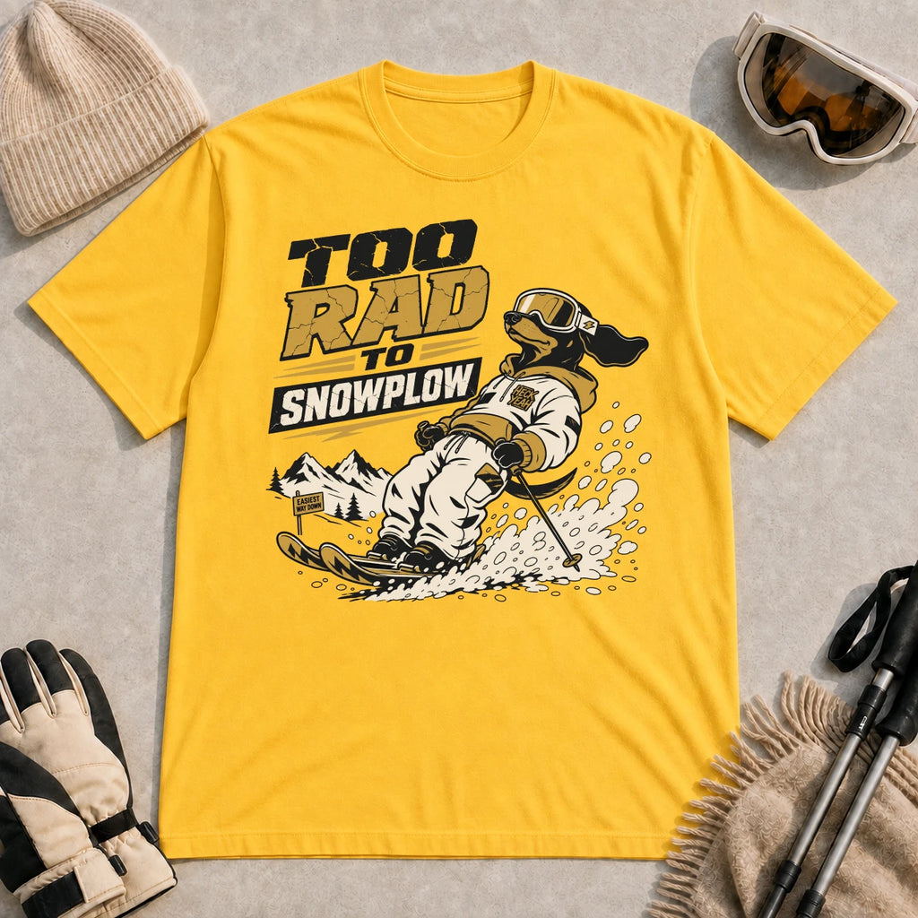 Daisy tee featuring a goggle-wearing dog skiing through the snow, with the phrase “Too Rad to Snowplow.”