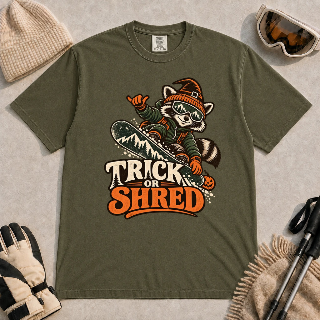 Hemp tee featuring a raccoon snowboarding in Halloween gear and a witch hat above the phrase “Trick or Shred.”