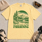 Butter tee featuring a green vintage mountain lake and evergreen forest scene with the phrase “Welcome to Paradise.”