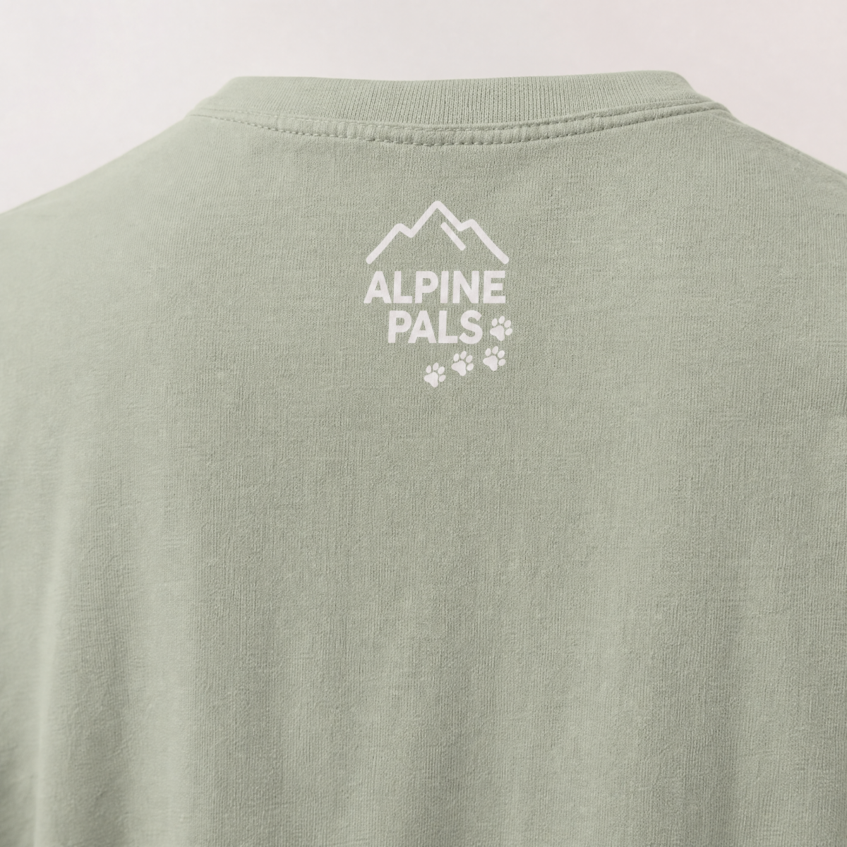 Green shirt with 'Alpine Pals' logo on a light gray background