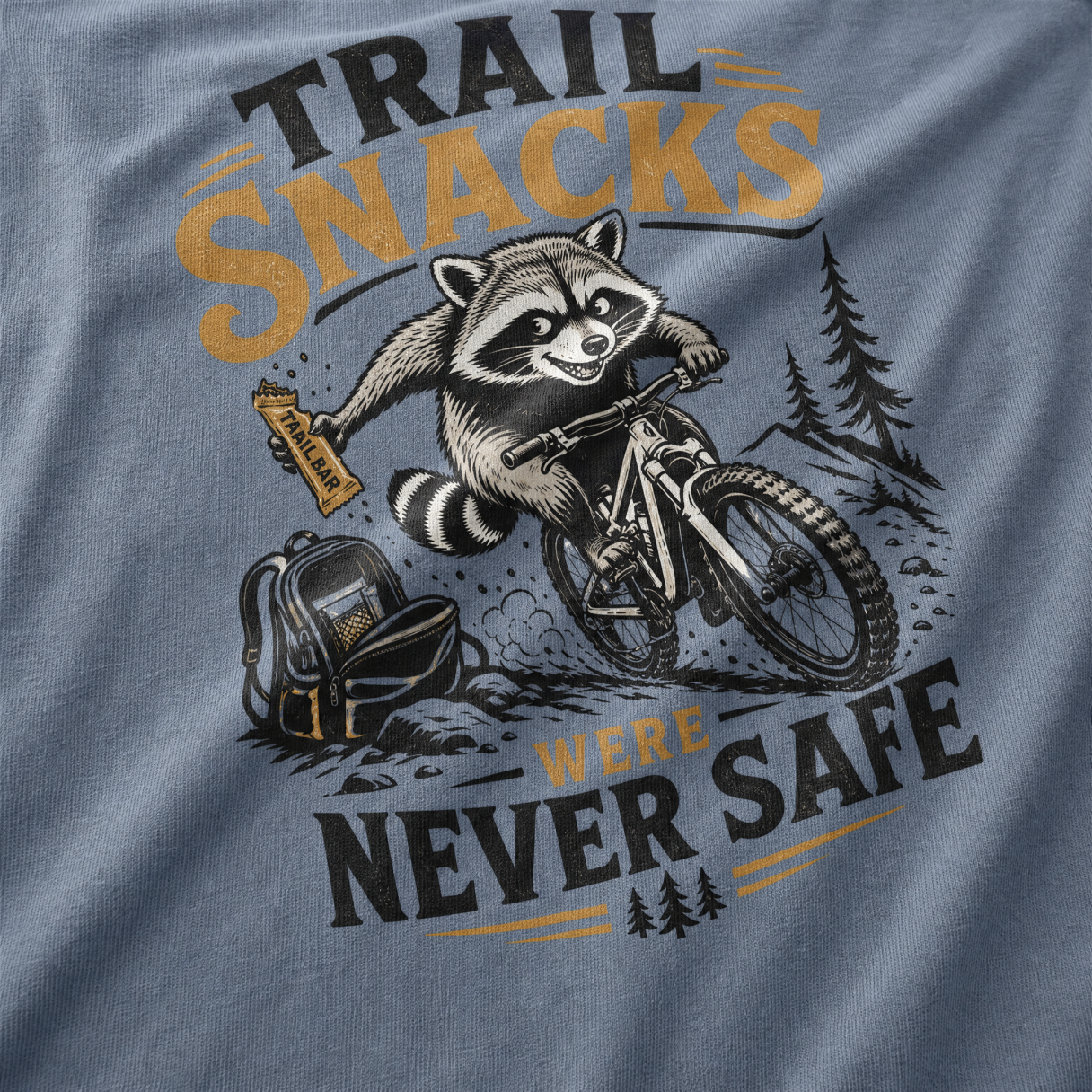 T-shirt with a raccoon riding a bike and text 'Trail Snacks Were Never Safe' on a gray background