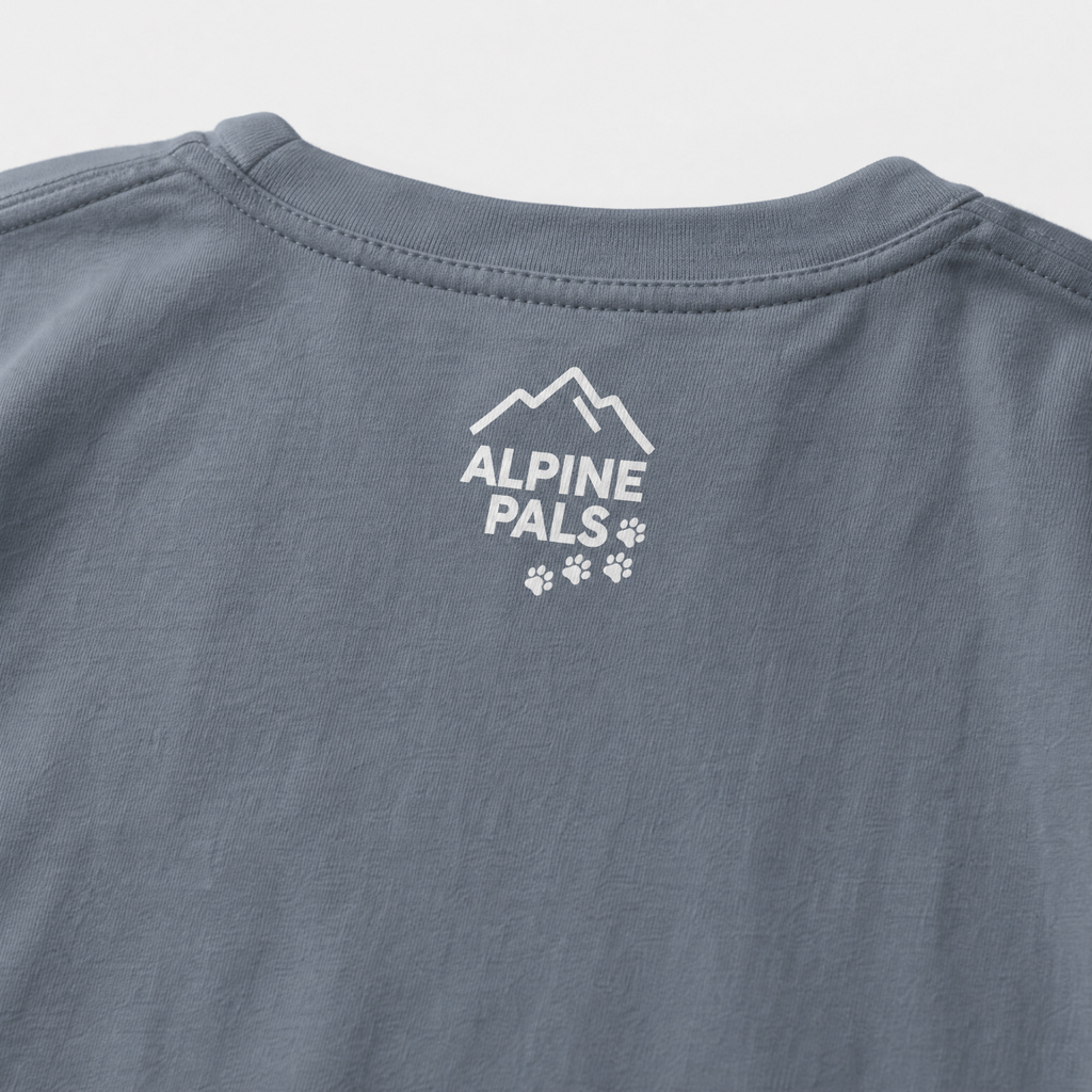 Blue jean colored shirt with 'Alpine Pals' logo on a light gray background