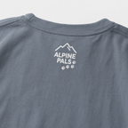 Blue jean colored shirt with 'Alpine Pals' logo on a light gray background