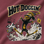 T-shirt with a cartoon dog skiing in a mountainous landscape and 'HOT DOGGIN'' text.