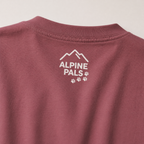 Brick colored shirt with 'Alpine Pals' logo on a light gray background