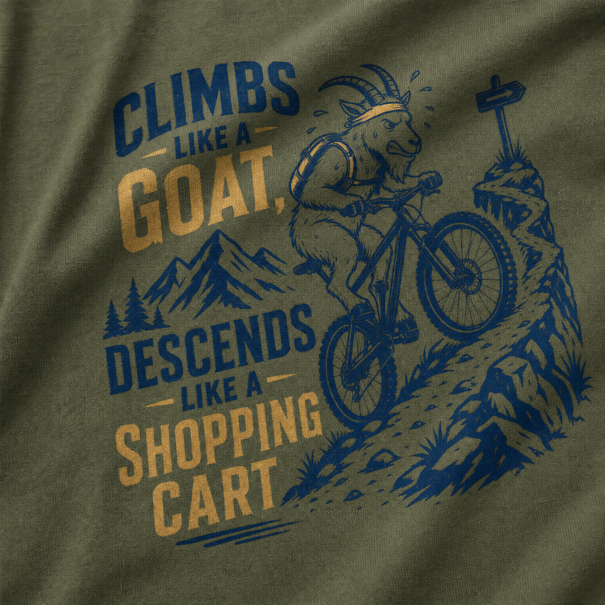 T-shirt with graphic of a goat riding a bike and text 'Climbs like a goat, descends like a shopping cart' on a green background.