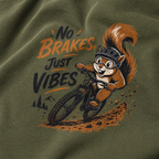 T-shirt with a squirrel riding a bike and 'No Brakes, Just Vibes' text on a green background