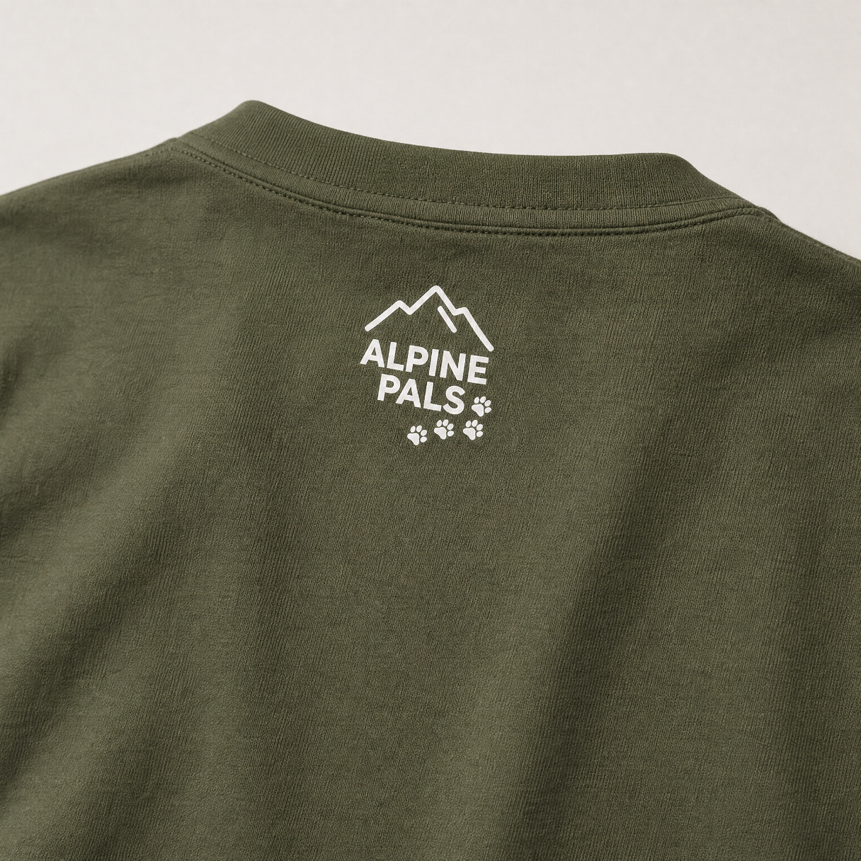 Green shirt with 'Alpine Pals' logo on a white background