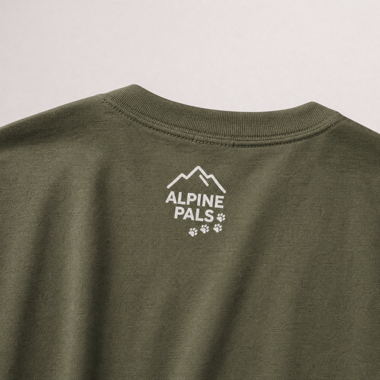 Green shirt with 'Alpine Pals' logo on a light gray background