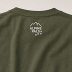 Hemp colored shirt with 'Alpine Pals' logo on a plain background